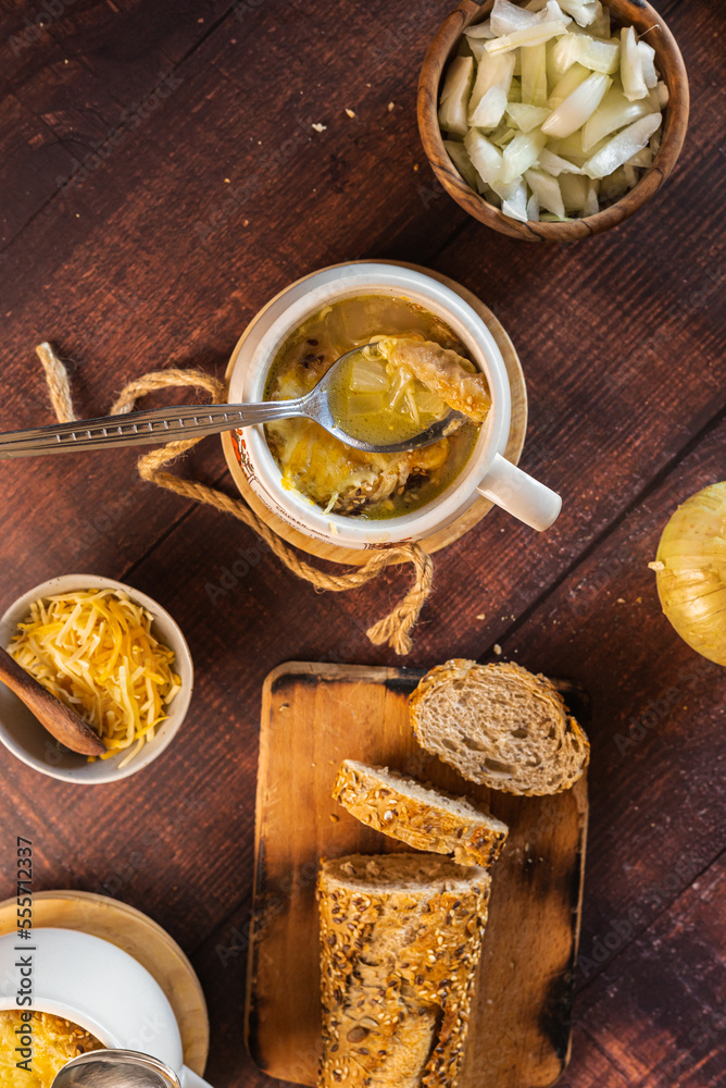 homemade onion soup on a wooden table homemade onion soup on a wooden table