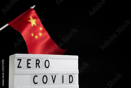 Zero Covid inscription on a dark background with a Chinese flag. Protest and Cancel Quarantine photo