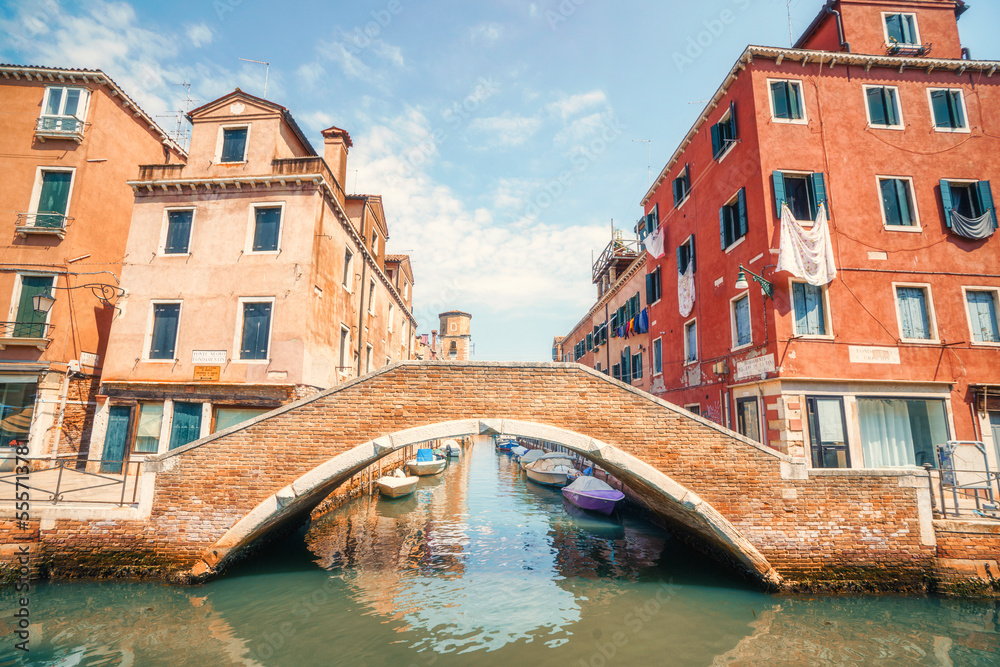 Bridge over a small Venice street canal in Italy on a beautiful summer day