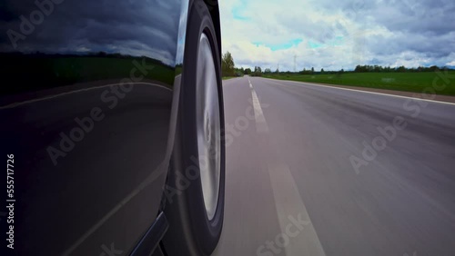 Driving a car on a country road, Wheel spinning in sunset, Low camera position 