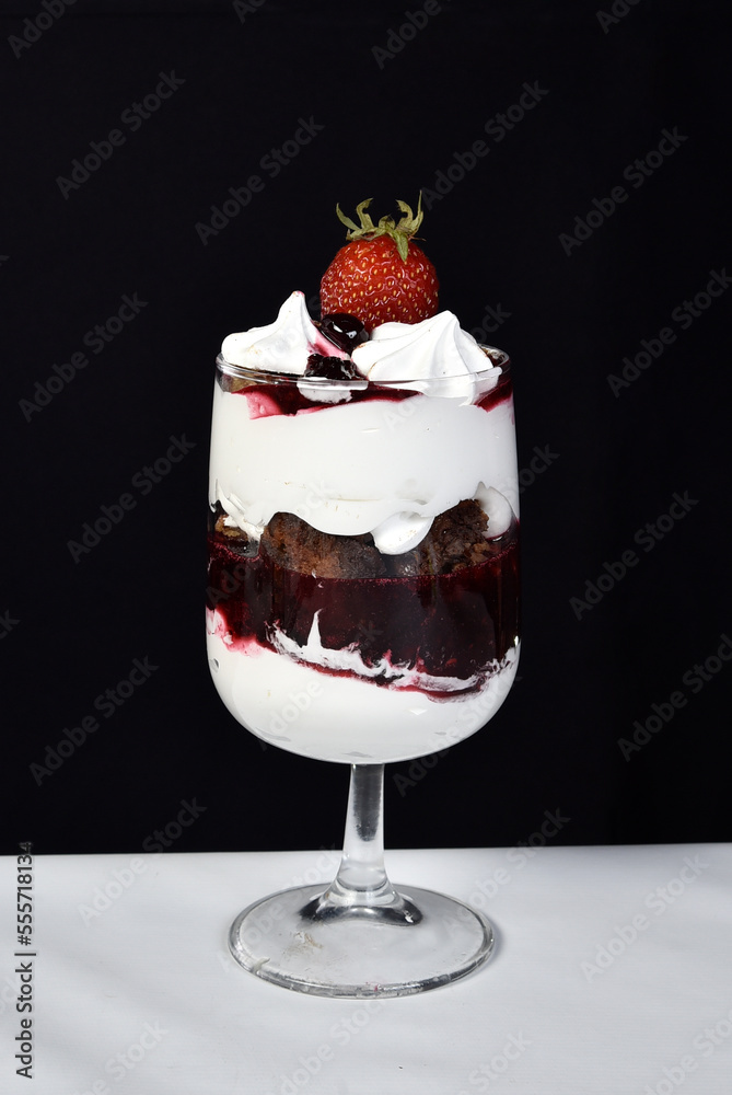 dessert in bowl with fruits on black background dessert in bowl with fruits on black background