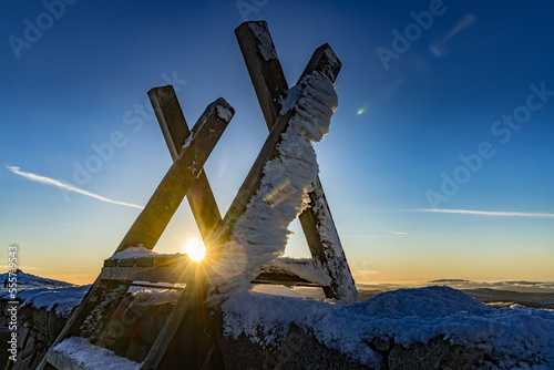 Wooden Stile at sunset with ice stuck to it on Slieve Meelmore, Mourne Mountains, County Down, Northern Ireland photo