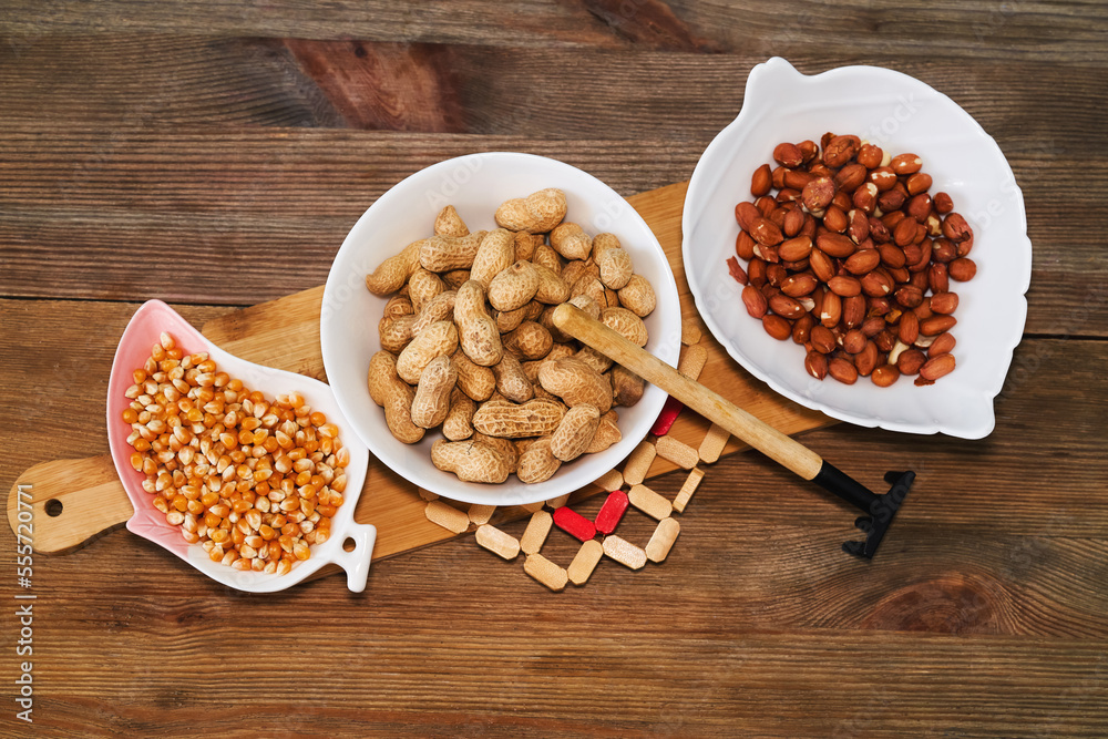 Assortment of nuts in bowls. Peanuts, pine nuts top view