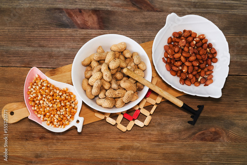 Obraz na płótnie Assortment of nuts in bowls. Peanuts, pine nuts top view w salonie
