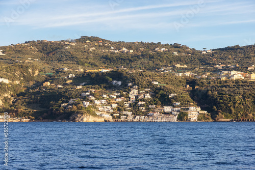 Fototapeta Naklejka Na Ścianę i Meble -  Rocky Coast and Homes near Touristic Town, Sorrento, Italy. Amalfi Coast. Sunny Evening