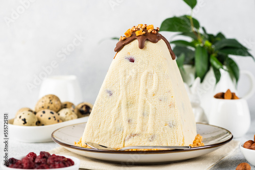 Traditional cottage cheese Easter paskha and eggs on white table. Russian paskha. Easter dessert. Easter table. Still life. Cottage cheese dessert. photo