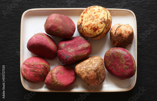 Photography of red and white Kola nuts on slate for food illustrations