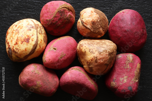 Photography of red and white Kola nuts on slate for food illustrations