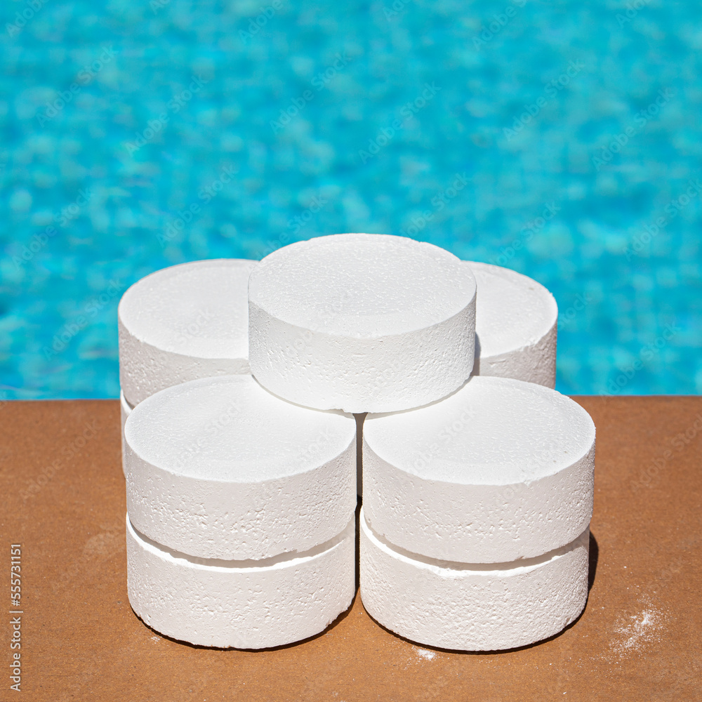 Stacked chlorine tablets on the edge of the pool for disinfection of