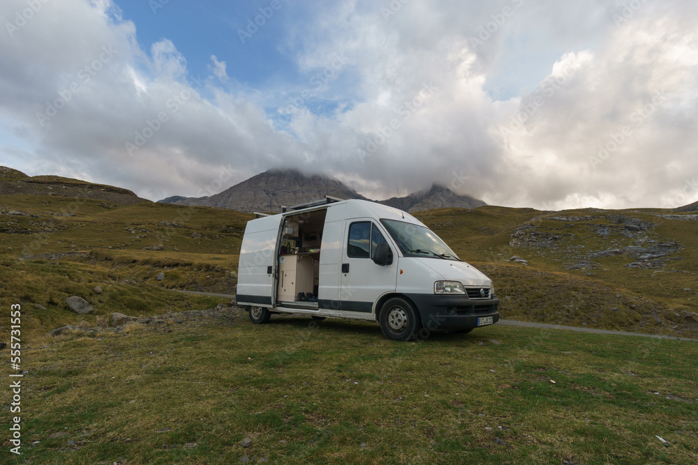 Beautiful mountain landscape near Gavarnie with camper van on meadow at Col de Tentes in the Pyrenees with peak of Taillon, Nouvelle-Aquitaine, France