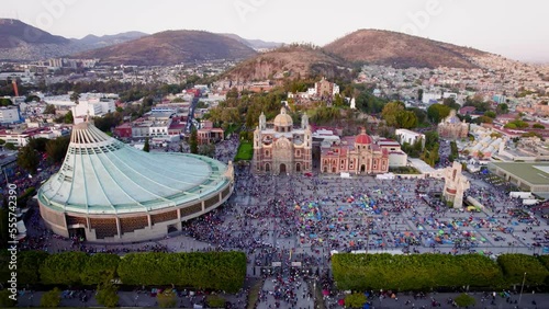 Aerial view of Basilica of Our Lady of Guadalupe. Virgin Mary's day pilgrimage. The old and the new Basilica. Basilica de Nuestra Señora Guadalupe, La Villa atrium. Mexico City. Drone shot dolly shot photo