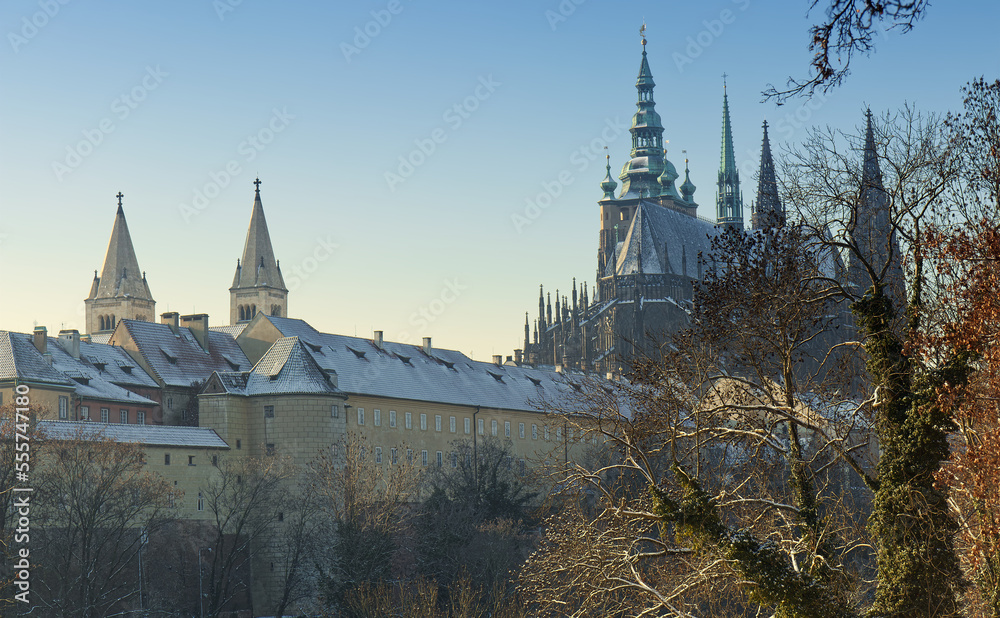 The view of the Hradcany in Prague. In the left foreground is the white tower and behind it are the 2 towers of St. George Basilica. On the right is St Vitus cathedral.
