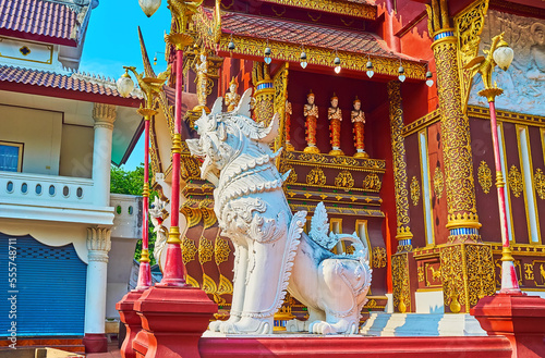 The Singha lion against the shrine of Wat Saen Muang Ma, Chiang Mai, Thailand photo