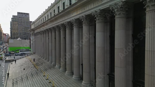 Flight shot around Moynihan Train Hall. Historic building of former main post office building with wide stairs and row of columns. New York City, USA photo