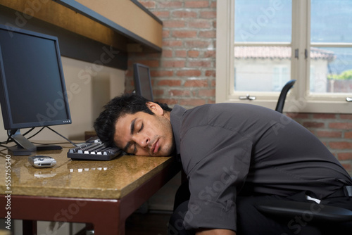 Businessman Asleep at Desk photo