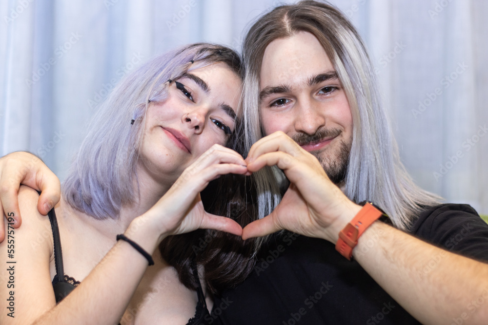 Couple in love sitting making a heart shape with their hands, Young ...