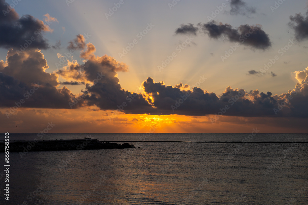 rayons de soleil au travers des nuages lors d'un lever de soleil en bord de mer rayons de soleil au travers des nuages lors d'un lever de soleil en bord de mer