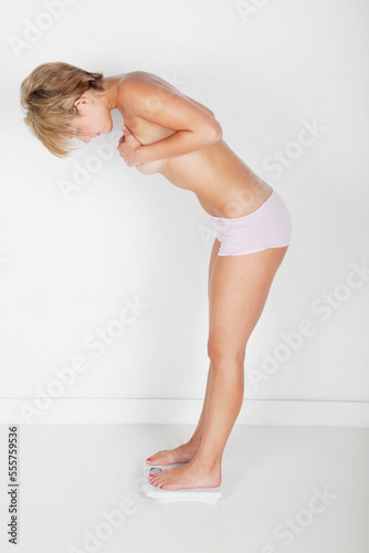 Woman Weighing Self