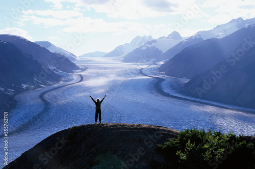 Silhouette of Person Looking at Salmon Glacier, Coast Mountains, British Columbia, Canada photo