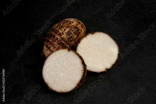 Portion of taro, also known as Cara or Yam, over black background photo