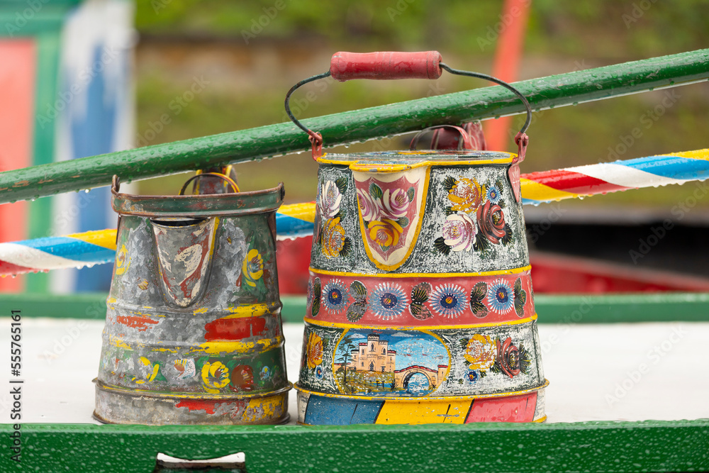 A traditional boater's coal scuttle, painted maybe a century ago, on the roof of a house boat