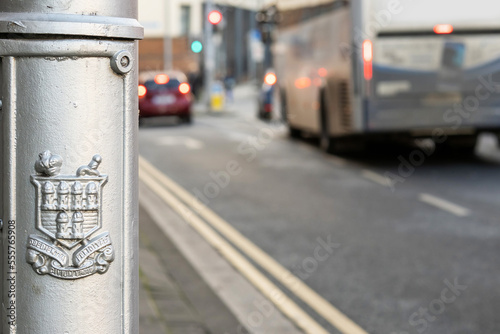 Canvas Print Dublin city logo on a lamp post , city traffic out of focus in the background
