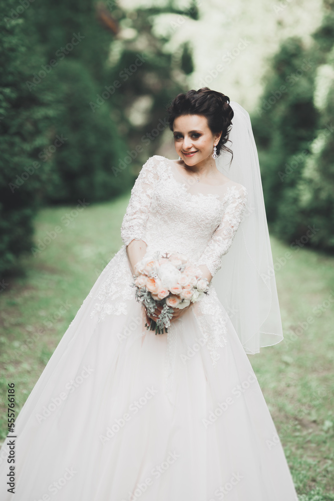 Portrait of stunning bride with long hair posing with great bouquet Portrait of stunning bride with long hair posing with great bouquet