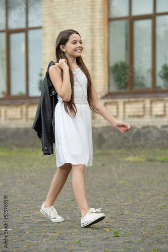 glad pretty teen girl. adorable girl fashion model. teenager girl walking outdoor