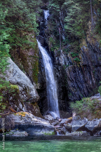 High waterfall cascades over cliff into the sea