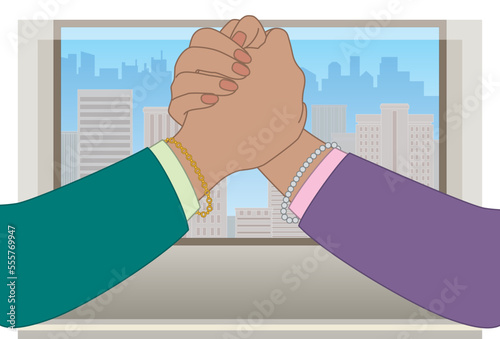 business women arm wrestling on office desk, closeup view, window showing buildings and city skyline in background