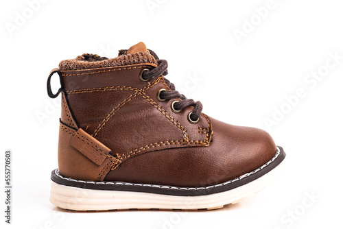 Brown children's shoe made of leather for a boy on a white background. Space for text. Close-up.