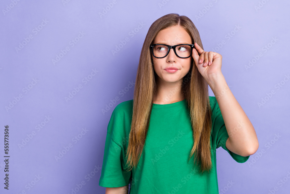 Photo of serious clever lady wear green stylish clothes look empty space interesting offer isolated on purple color background Photo of serious clever lady wear green stylish clothes look empty space interesting offer isolated on purple color background