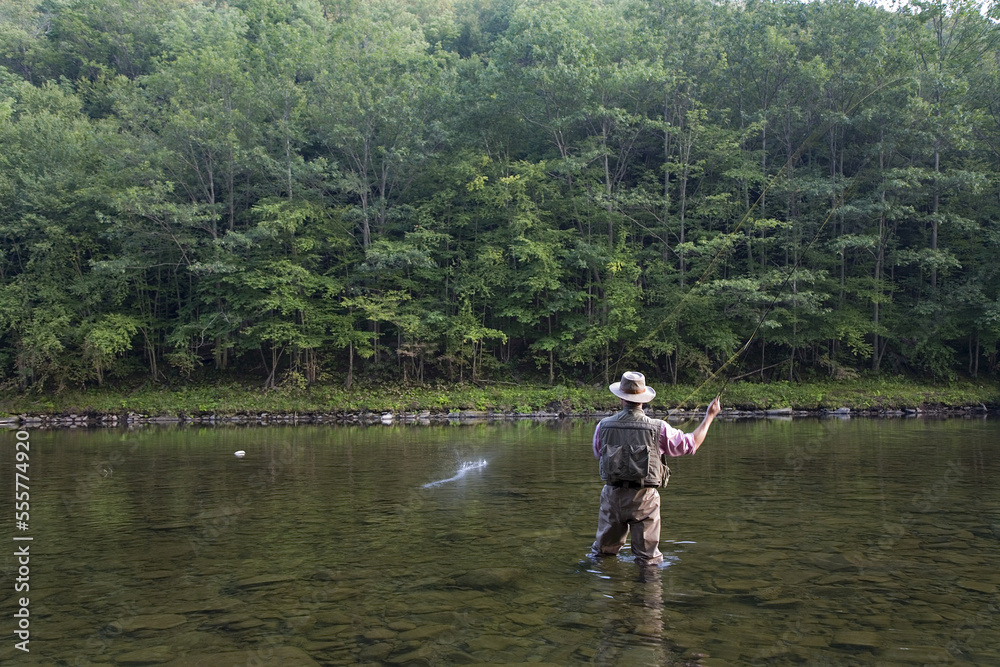 Man Fly Fishing, Cairns Pool, Beaverkill River, Catskill Park, New York, USA Man Fly Fishing, Cairns Pool, Beaverkill River, Catskill Park, New York, USA