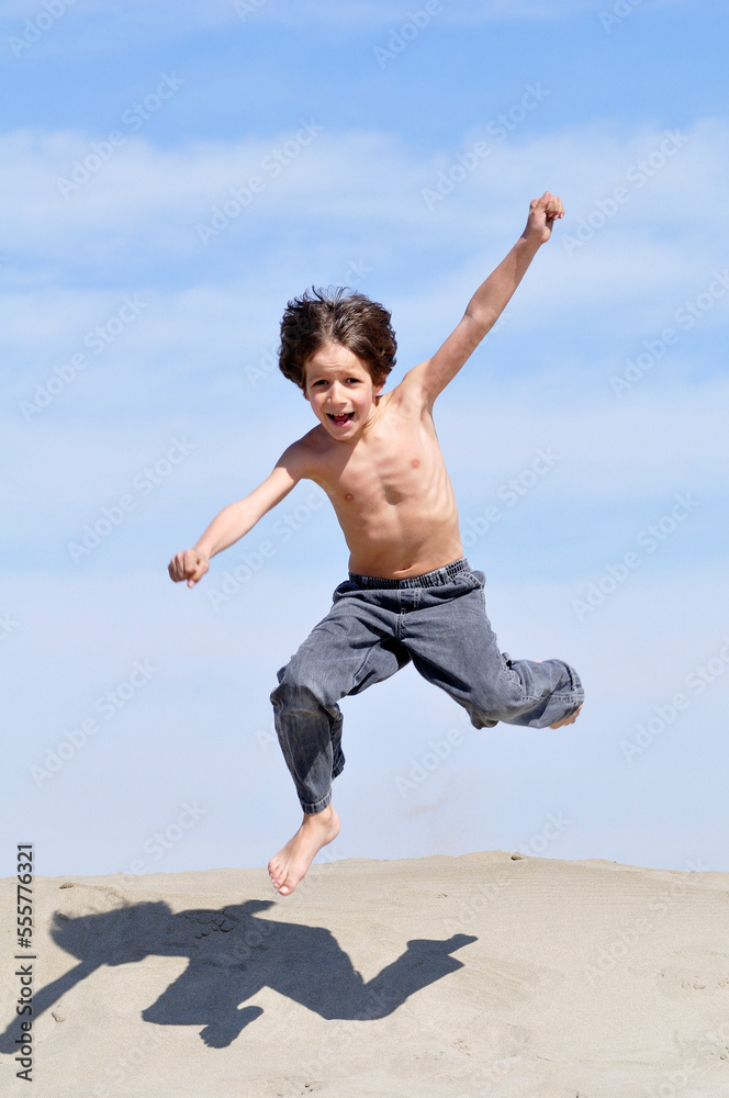 Little Boy Jumping on the Beach Little Boy Jumping on the Beach