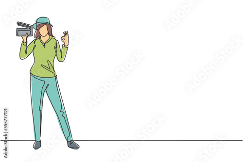 Single continuous line drawing female film director stands with gesture okay holding clapperboard and prepare camera crew for shooting at studio. One line draw graphic design vector illustration