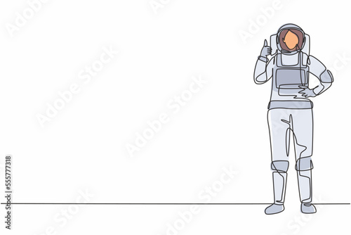 Single continuous line drawing female astronaut stands with thumbs-up gesture wearing space suit exploring earth, moon, other planets in the universe. One line draw graphic design vector illustration