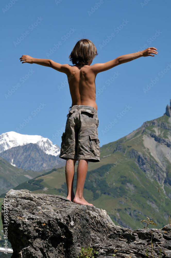 Back View of Boy Standing on Boulder, Alps, France Back View of Boy Standing on Boulder, Alps, France
