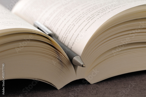 Close-up of Open Book and Pen