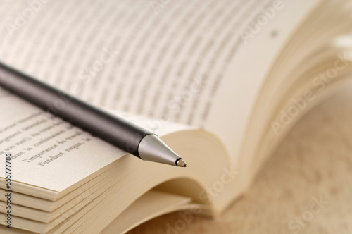 Close-up of Open Book and Pen photo