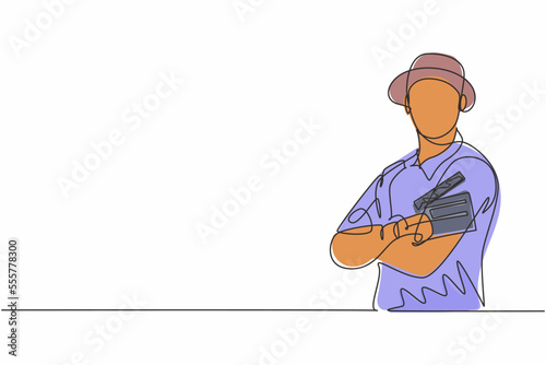 Single one line drawing young male film director cross arm on chest and hold clapping board. Professional profession occupation minimal concept. Continuous line draw design graphic vector illustration