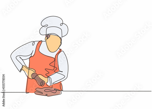 Single continuous line drawing of young happy male chef sparkling salt paper seasoning into meal dish. Preparing organic food for catering concept one line drawing design vector graphic illustration