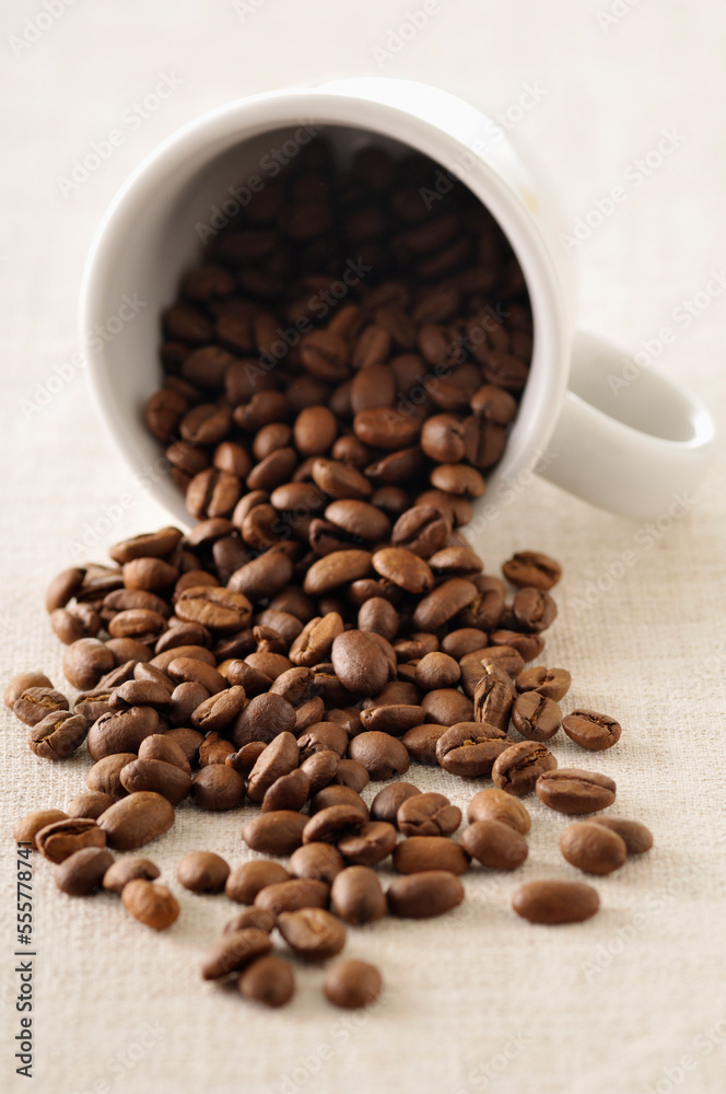Close-up of Coffee Beans Spilling out of Mug Close-up of Coffee Beans Spilling out of Mug