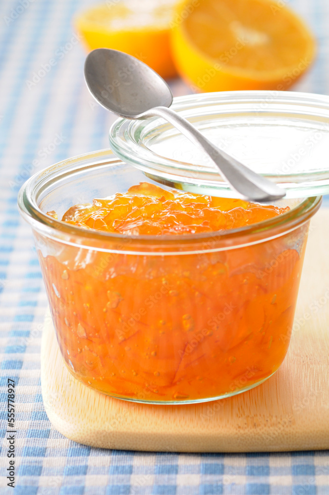 Close-up of Homemade Orange Marmalade with Spoon on Cutting Board Close-up of Homemade Orange Marmalade with Spoon on Cutting Board