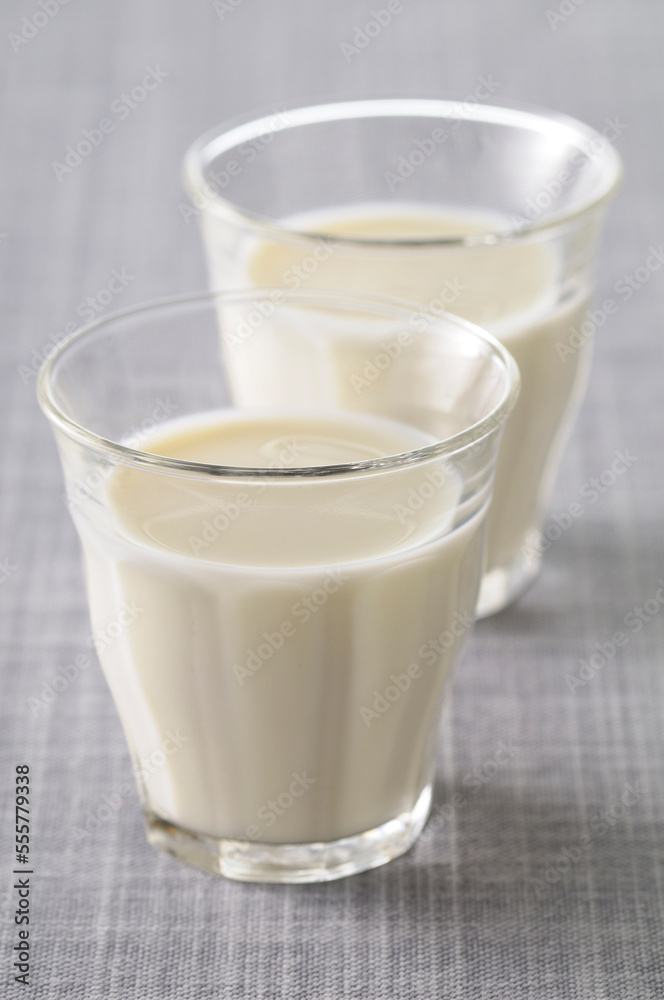 Two Glasses of Milk on Grey Background, Studio Shot Two Glasses of Milk on Grey Background, Studio Shot