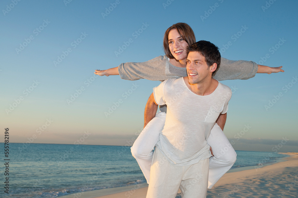 Man Piggybacking Woman on Beach, Reef Playacar Resort and Spa, Playa del Carmen, Mexico Man Piggybacking Woman on Beach, Reef Playacar Resort and Spa, Playa del Carmen, Mexico