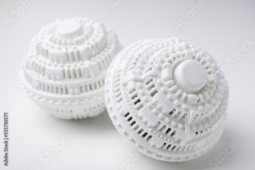 Dryer balls for washing machine on white table, closeup. Laundry detergent substitute