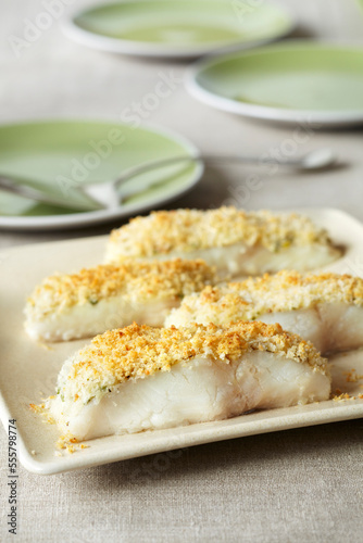 Panko crusted white fish pieces on a serving platter photo