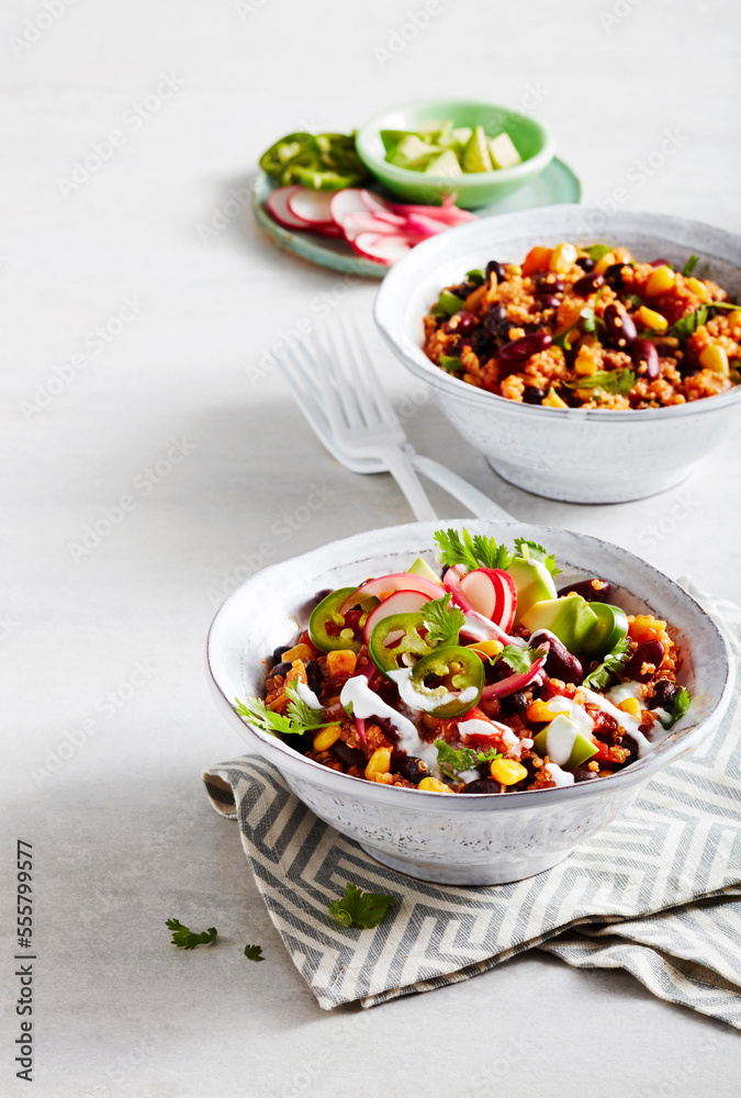 Bowls of vegetable chili with quinoa, beans and corn Bowls of vegetable chili with quinoa, beans and corn