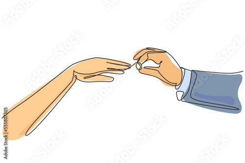 Single one line drawing groom puts ring on finger of bride. Bride and groom make vow of loyalty on their wedding day. Marriage ceremony celebration concept. Modern continuous line draw design graphic