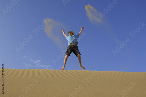 Boy Playing in Sand Dunes, Playa del Ingles, Cran Canaria, Canary Islands photo